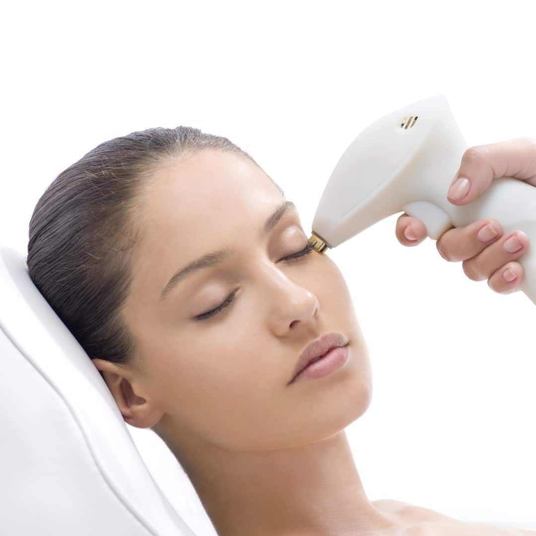 In Cooper City, a person is reclining with their eyes closed, receiving a luxurious facial treatment at a med spa. Using a state-of-the-art handheld laser device, the skilled therapist provides premium skincare services designed to rejuvenate and enhance the skin’s appearance.